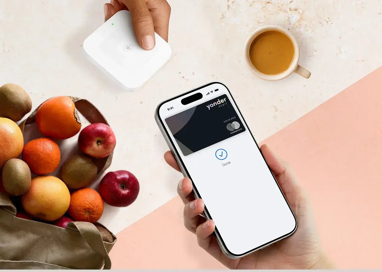 Yonder mobile payment app interface displayed alongside retail transaction terminal.